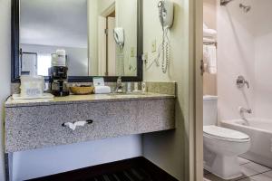a bathroom with a sink and a toilet and a phone at Quality Inn in Culpeper +20 photos