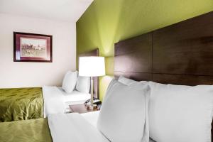 a hotel room with two beds and a lamp at Quality Inn in Culpeper