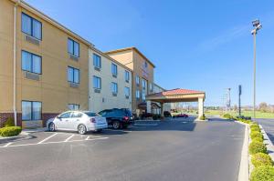 a hotel with cars parked in a parking lot at Comfort Suites in Wytheville