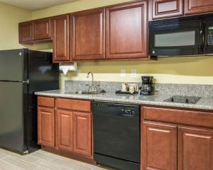 a kitchen with a stove, refrigerator, sink and microwave at MainStay Suites Williamsburg I-64 in Williamsburg