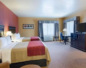 a hotel room with two beds and a flat screen tv at Comfort Inn & Suites Orange - Montpelier in Orange +26 photos
