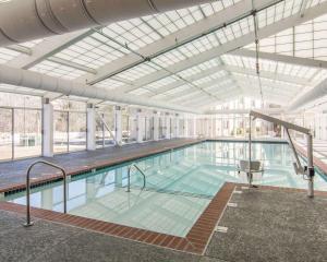 a large indoor swimming pool with a glass ceiling at Bluegreen Vacations Patrick Henry Sqr, Ascend Resort Collection in Williamsburg