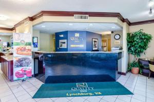 a lobby of a restaurant with a counter in the middle at Quality Inn Lynchburg near University in Lynchburg