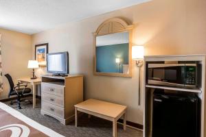 a small hotel room with a bed and a television at Quality Inn & Suites Exmore in Exmore