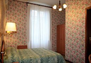Postel nebo postele na pokoji v ubytování Hotel Villa Flores