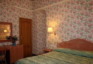 Postel nebo postele na pokoji v ubytování Hotel Villa Flores
