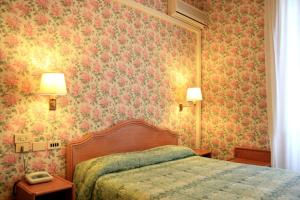 Postel nebo postele na pokoji v ubytování Hotel Villa Flores