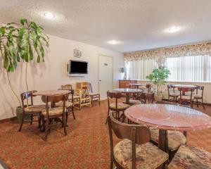 a dining room with tables and chairs and a tv at Comfort Inn On the Bay in Port Orchard