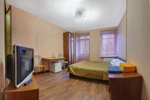 a room with a bed and a tv in it at RA Hotel at Tambovskaya 11 in Saint Petersburg