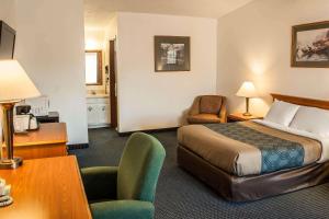 Habitación de hotel con cama, escritorio y silla en Econo Lodge Inn & Suites, en Hoquiam