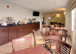 a restaurant with wooden tables and chairs and a counter at Sleep Inn Pasco Tri -Cities in Pasco