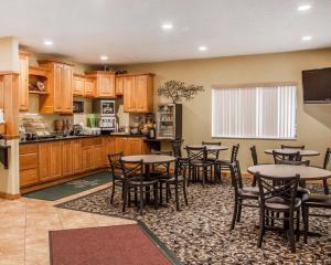 a kitchen and dining room with tables and chairs at Quality Inn in Beloit