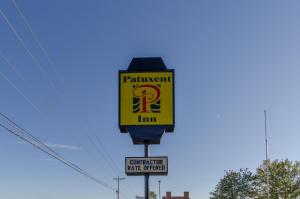 a sign for a gas station on a street at Patuxent Inn in La Plata