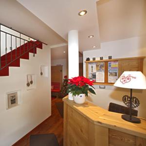 a living room filled with furniture next to a stairwell at Villa Seceda in Selva di Val Gardena