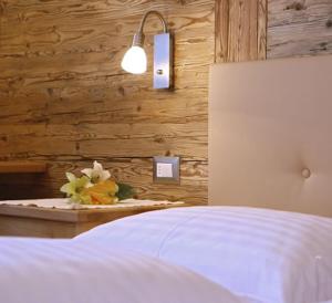 a bedroom with a bed and a lamp at Villa Seceda in Selva di Val Gardena