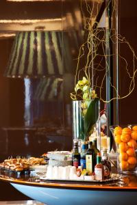 a table with food on it with oranges and other foods at JR Hotels Bari Grande Albergo delle Nazioni in Bari