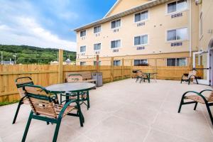a patio with tables and chairs and a building at Comfort Suites Wisconsin Dells Area in Portage