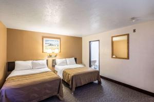 a hotel room with two beds and a mirror at Quality Inn Moses Lake in Moses Lake +37 photos