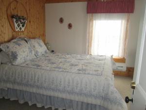 A bed or beds in a room at Gîte Les Acres Tranquilles B&B