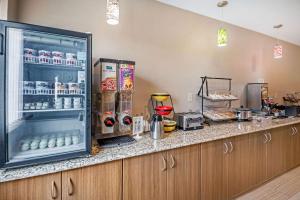 a kitchen with an open refrigerator with drinks at Econo Lodge in La Crosse