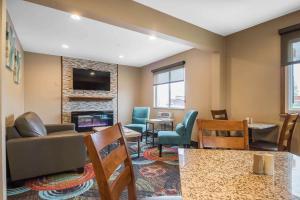 a living room with a couch and chairs and a fireplace at Quality Inn in Janesville