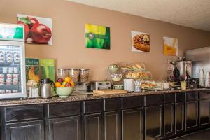 a kitchen with a counter with food on it at Quality Inn & Suites in West Bend