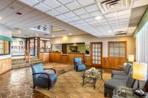 a lobby with a waiting room with chairs and a table at Quality Inn Wausau in Wausau
