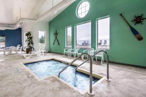 a swimming pool in a room with green walls at Comfort Suites at Par 4 Resort in Waupaca