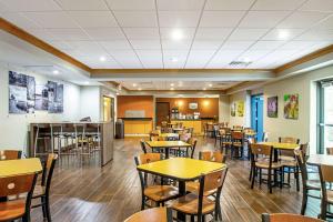 a dining room with tables and chairs in a restaurant at Sleep Inn & Suites Madison - Monona in Madison