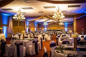 a banquet hall filled with tables with white table linens at Sleep Inn & Suites Conference Center Eau Claire in Union