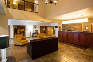 a lobby with a couch and chairs and a bar at Sleep Inn & Suites Conference Center Eau Claire in Union