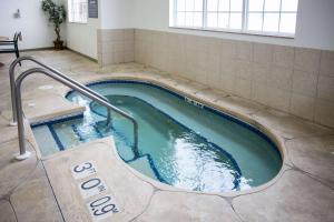 a swimming pool with a hot tub in a building at Sleep Inn & Suites Conference Center Eau Claire in Union