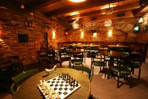 a chess board on a table in a restaurant at Amrita Hotel in Liepāja