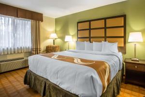 a hotel room with a large bed and a window at Quality Inn & Suites Marinette in Marinette
