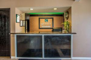 a restaurant with a counter with a sign on it at Quality Inn & Suites in West Bend