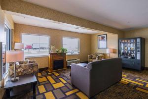 a living room with a couch and a refrigerator at Quality Inn & Suites Belmont Route 151 in Belmont