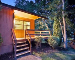 a small orange house with a porch and stairs at Bluegreen Vacations Christmas Mountain Village, an Ascend Resort in Wisconsin Dells