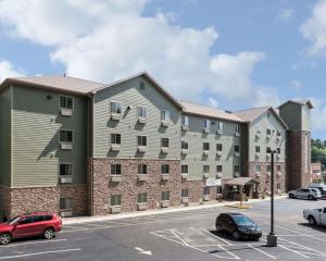 a rendering of a large apartment building with a parking lot at Suburban Studios Morgantown in Morgantown