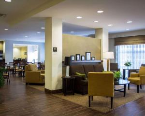 a lobby of a hospital with chairs and tables at Sleep Inn & Suites Moundsville - Wheeling in Moundsville