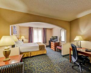 a hotel room with a bed and a desk at Quality Inn Spring Mills - Martinsburg North in Martinsburg