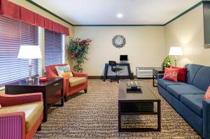 a living room with couches and a table at Quality Inn in Princeton