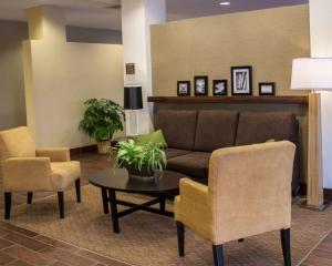 a living room with a couch and two chairs and a table at Sleep Inn & Suites Moundsville - Wheeling in Moundsville