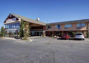 a large building with cars parked in a parking lot at Quality Inn Evanston near Wyoming Downs in Evanston