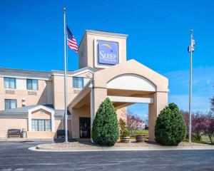 a large building with a flag on top of it at Sleep Inn & Suites Princeton I-77 in Princeton