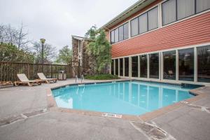a swimming pool in front of a building at Clarion Inn in Merrillville