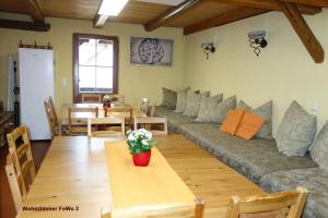 a living room with a couch and a table at Lehmhof-Lindig in Kahla
