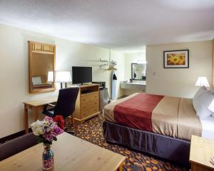 a hotel room with a bed and a desk at EconoLodge Phillipsburg in Phillipsburg