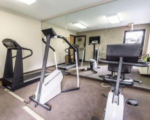 a gym with several tread machines and a mirror at Sleep Inn in Louisville