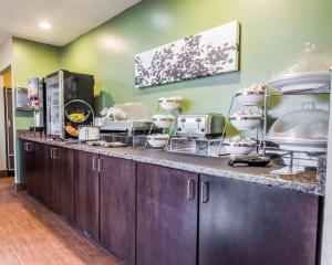 a kitchen with a counter with many dishes on it at Sleep Inn in Louisville