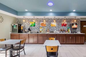 a restaurant with tables and chairs and a counter at Quality Inn Cadiz in Cadiz